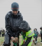 Helping a young person to plant a tree at the first 'One Tree Per Child' planting in Bristol.